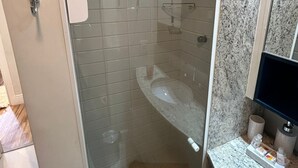 A glass-enclosed shower with a marble countertop and a sink. - Get a Flat - 604  Ibirapuera (São Paulo)