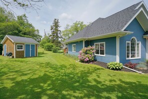 A two-story house with a well-maintained lawn and a small shed. - Harbourview Retreat - Waterview Luxury Home Steps from the Inn at Bay Fortune (Rock Barra)