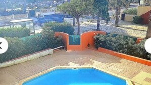 A swimming pool with a view of a cityscape. - Residence with swimming pool and sea view - Haven of peace in the heart of the city (Le Barcarès)
