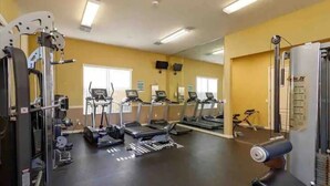 A gym with treadmills, weight machines, and exercise equipment. - Updated Family Retreat in Gated Resort Community - Pool, Gym, Near Parks & MCO (Kissimmee)
