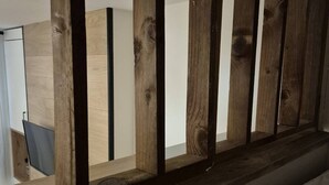 A wooden railing with a view of a room with a white wall and a door. - Cozy 17m² studio, near cable car, 2/4 pers, parking (Cauterets)