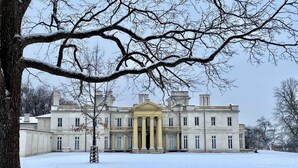 A large, classical building with a symmetrical facade, large windows, and a central entrance with columns.