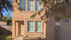 A two-story brick building with a front door, windows, and a sign that reads "Candle Maker's". - Candle Maker's Cove: King Bed, Fiber WiFi, Full Kitchen Access (Leander)