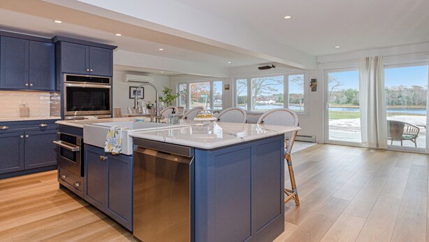 A modern kitchen with a large island, built-in appliances, and a view of the outdoors. - Coastal Retreat at Lemon Tree Cottage (Marion)