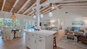 A spacious kitchen with a large island, wooden ceiling beams, and pendant lighting. - 🏝️Private Pool | Canal Front | Beautiful Life on Madison🏝️ (Fort Myers Beach)