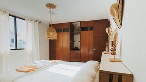 A bedroom with a bed, a wardrobe, and a window. - House with Private Pool - 3BR Cancun Downtown Zone (Cancún)