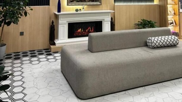 A modern living room with a fireplace, a sofa, and a painting on the wall. - Luxury apartments by city (Baku)
