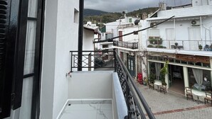 A balcony with a view of a courtyard and neighboring buildings. - BH1039 - A -Nektar Studio (7H9J+JXC Latsida, Greece)