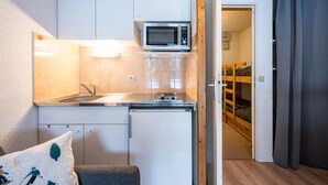 A compact kitchen with a microwave, sink, and a small refrigerator. - Le Cocon des Pistes - Station à 10 minutes (Les Contamines-Montjoie)