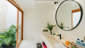 A modern bathroom with a large mirror, a sink, and a small plant. - Stylish 2BR Private Pool Villa • 5 Mins to Bingin Beach (Bali)
