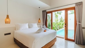 A large bed with white linens, two hanging lamps, and a view of a swimming pool through a glass door. - Stylish 2BR Private Pool Villa • 5 Mins to Bingin Beach (Bali)