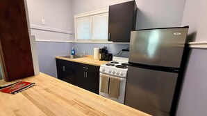 A compact kitchen with a stove, sink, and refrigerator. - Western-Themed & Conveniently-Located Apartment in Tonawanda (Tonawanda)