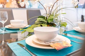 A dining table set with white bowls, plates, and a napkin. - Amazing Family House w pvt Pool - 1605 (Clermont)