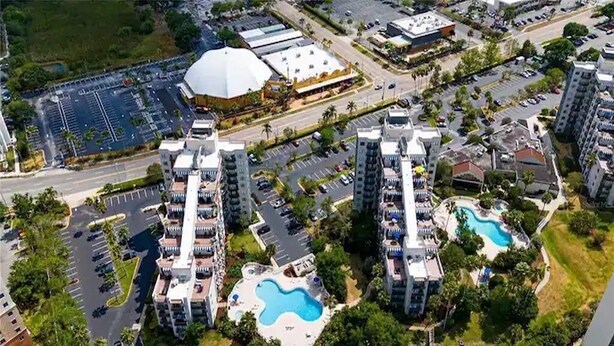 A high-rise hotel with two prominent towers, each with a swimming pool and a rooftop terrace. - Enclave Studio – 1 mi to Universal w/ Pool (Orlando)