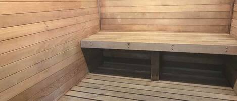 A sauna with wooden walls and benches.