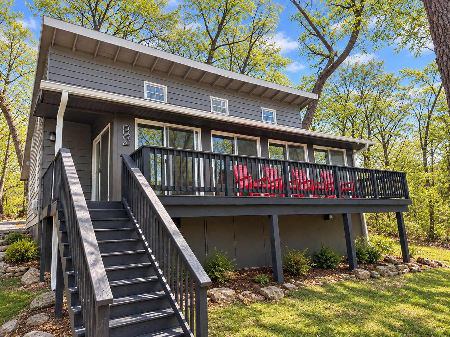 A two-story house with a covered porch and a staircase leading to the entrance.