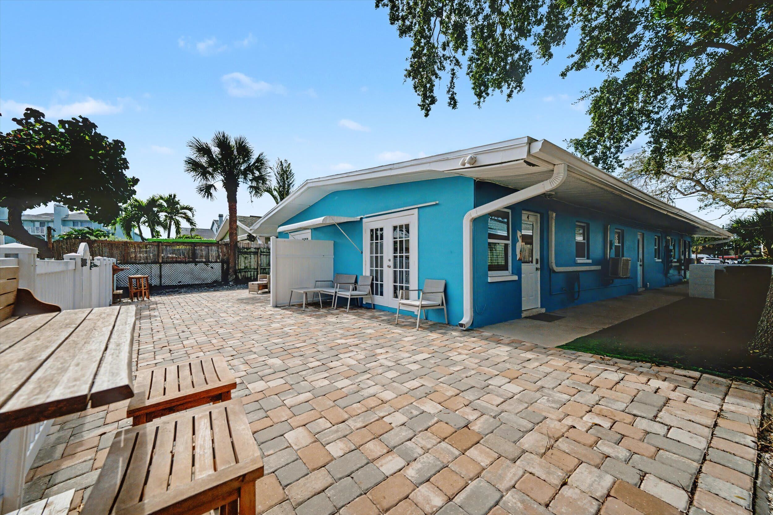 Charming coastal home with spacious paved outdoor area.