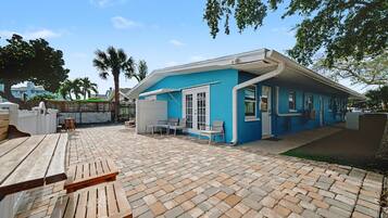 Charming coastal home with spacious paved outdoor area.