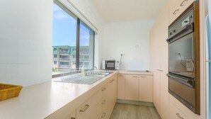 Microwave, oven, stovetop, cookware/dishes/utensils - Ocean Views at Acacia - Beachfront Apartment (Kingscliff)