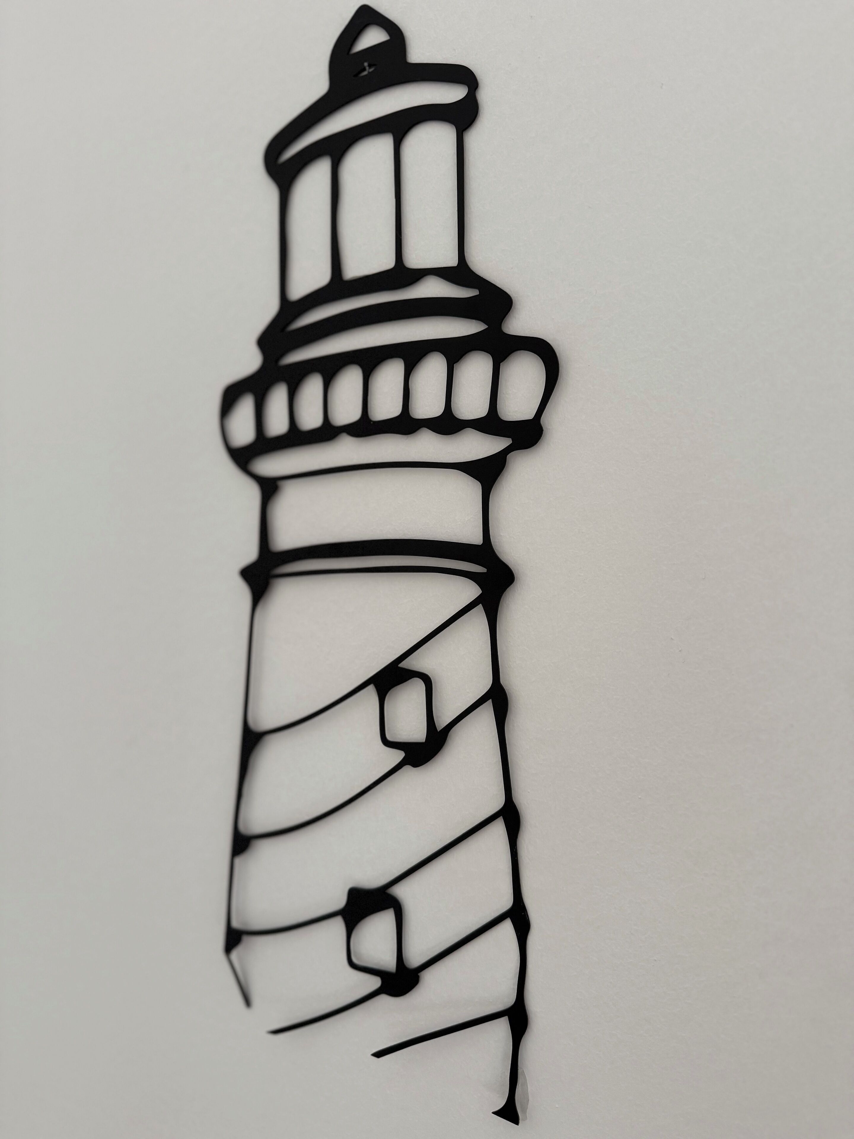 A black and white line drawing of a lighthouse.