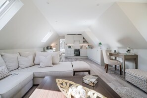 Een modern loft appartement met een woongedeelte, een eethoek en een keuken.