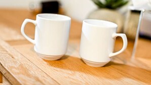 Two white ceramic mugs on a wooden surface. - The George Inn Rooms - Room 5 (Great Missenden)