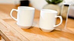 Two white ceramic mugs on a wooden surface. - The George Inn Rooms - Room 2 (Great Missenden)