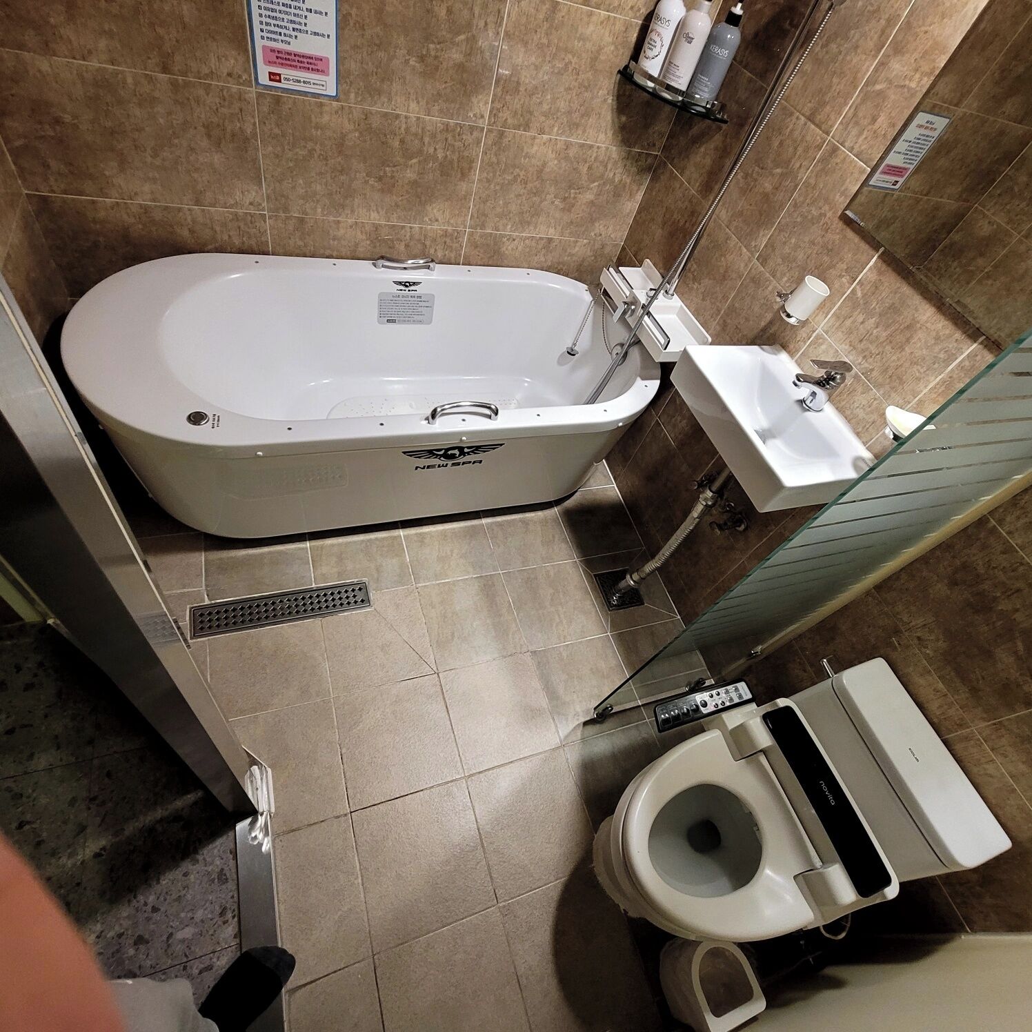 A bathroom with a bathtub, a toilet, and a sink.