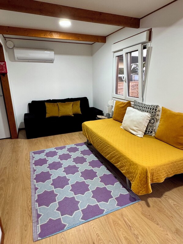 Family Triple Room, Patio, Garden View | Living area