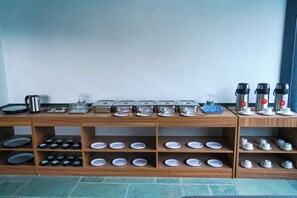 A buffet setup with various dishes and beverages. - The Lovedale Kodaikanal Stay & Hotel (Kodaikanal)