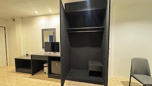 A room with a large wardrobe, a desk with a computer, a chair, and a mirror. - Chapter 26 Guesthouse (Patong)