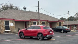 A building with a stone facade and a red roof. - The Mint Motel (Arlington)