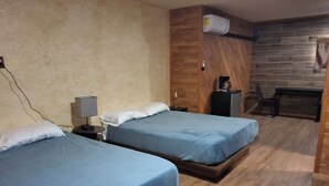A room with two beds, a desk, a chair, and a coffee machine. - The Mint Motel (Arlington)
