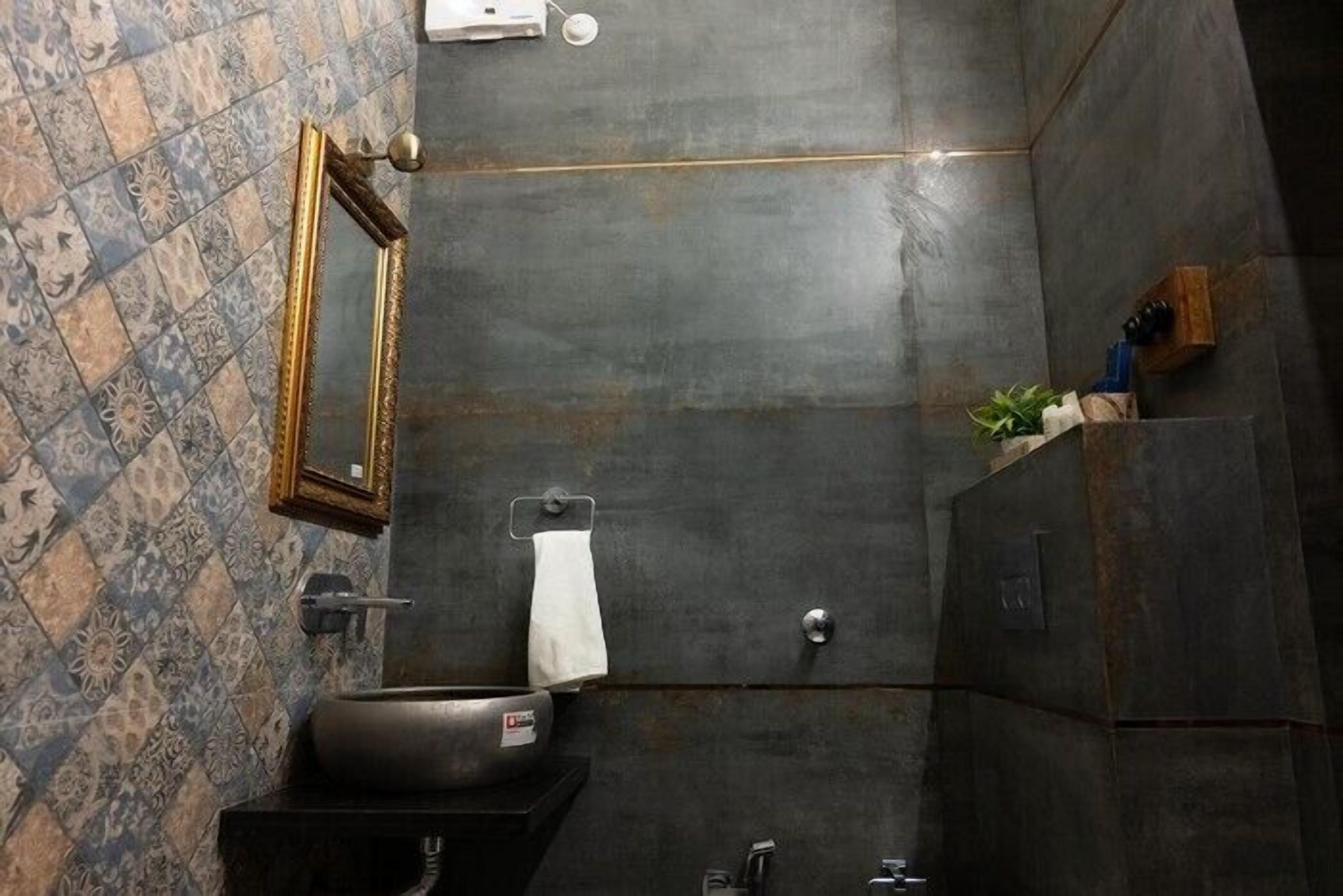 A bathroom with a large sink, a mirror, and a towel rack.