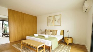 A modern bedroom with a large bed, a wooden bench, a bedside table, and a view of the outdoors. - Carvoeira Nature & Serenity Escape by Lisbeyond (Barril)