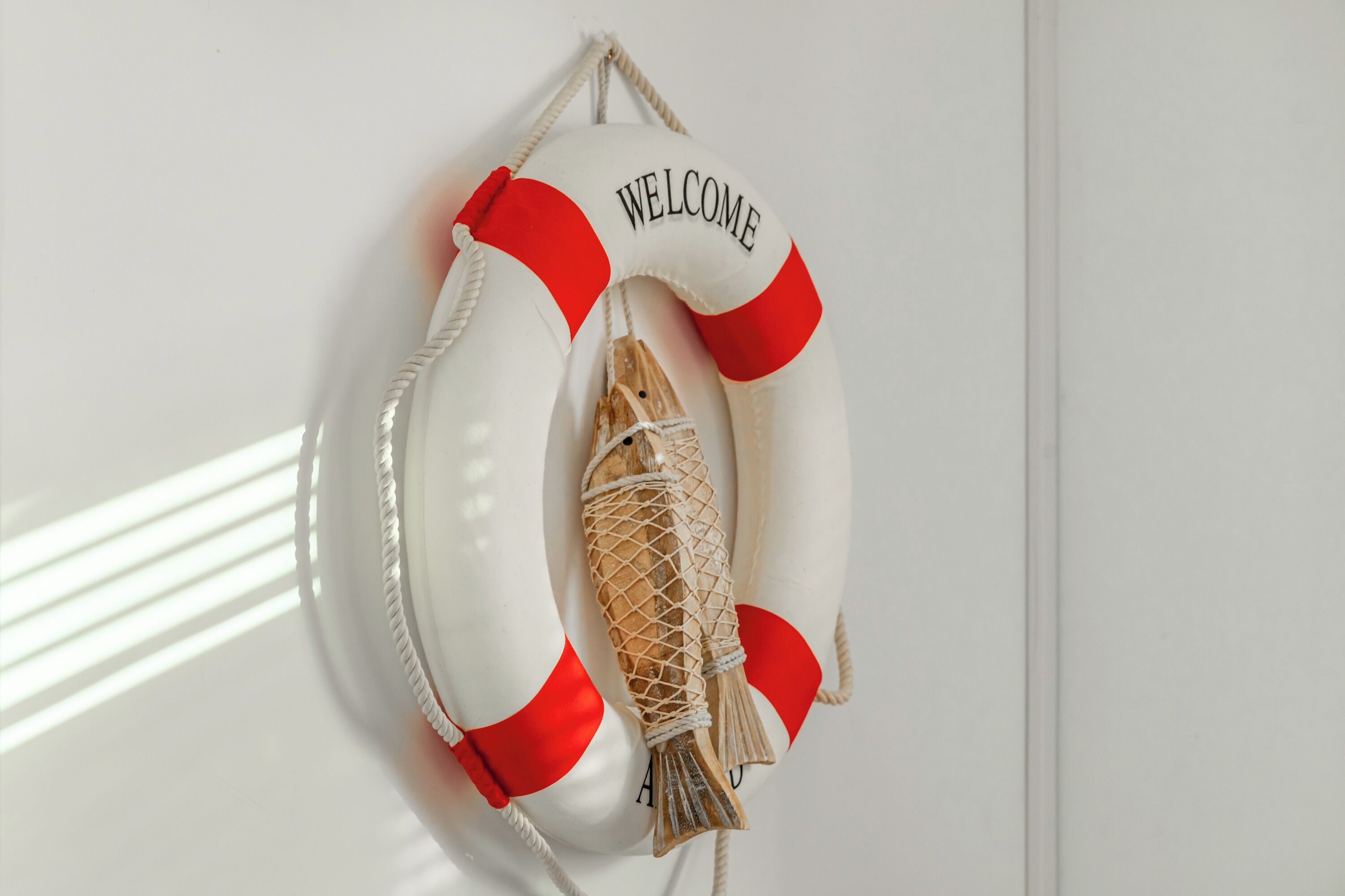 A life preserver with the word "WELCOME" and a rope tied around it.