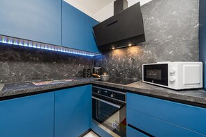 Apartamento básico, patio, vistas al patio | Cocina privada | Frigorífico grande, microondas, horno y placa de cocina