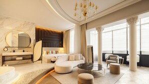 A luxurious living room with a curved sofa, a round coffee table, and a large mirror. - Maison Bauchart (Paris)