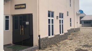 A building with a reception area, a push door, and a satellite dish.