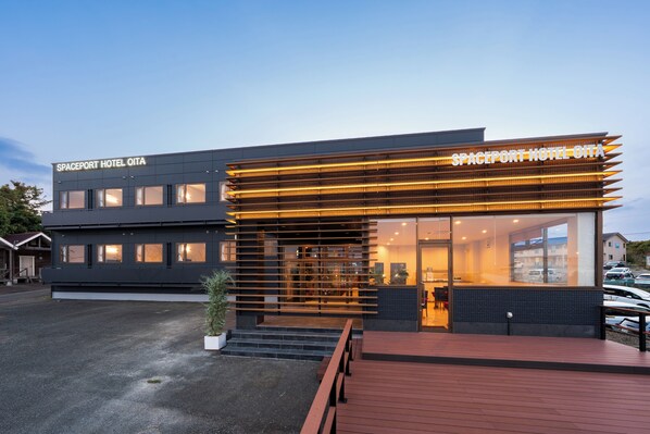 A modern hotel with a flat roof, large windows, and a wooden deck. - SPACEPORT HOTEL OITA (Kunisaki)