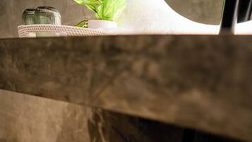A wooden shelf with folded towels.