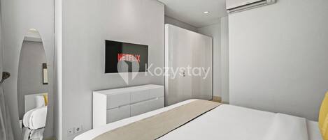 A modern bedroom with a large bed, a built-in TV, a white wardrobe, and an air conditioning unit.