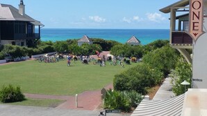 A coastal hotel with a grassy lawn, bicycles, and a clear view of the ocean. - Inlet Sands 105 (Panama City Beach)