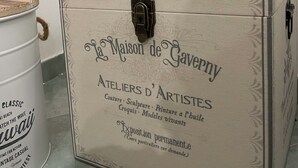 A vintage-style trunk with a lamp on top, labeled "L'Hotel de Gavepy" and "Ateliers d'Artistes." - LUISA ROOM (Sampieri)
