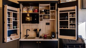 A compact kitchen with open shelving, a sink, and a coffee machine. - Pervicacia Lux Studios (Dubrovnik)