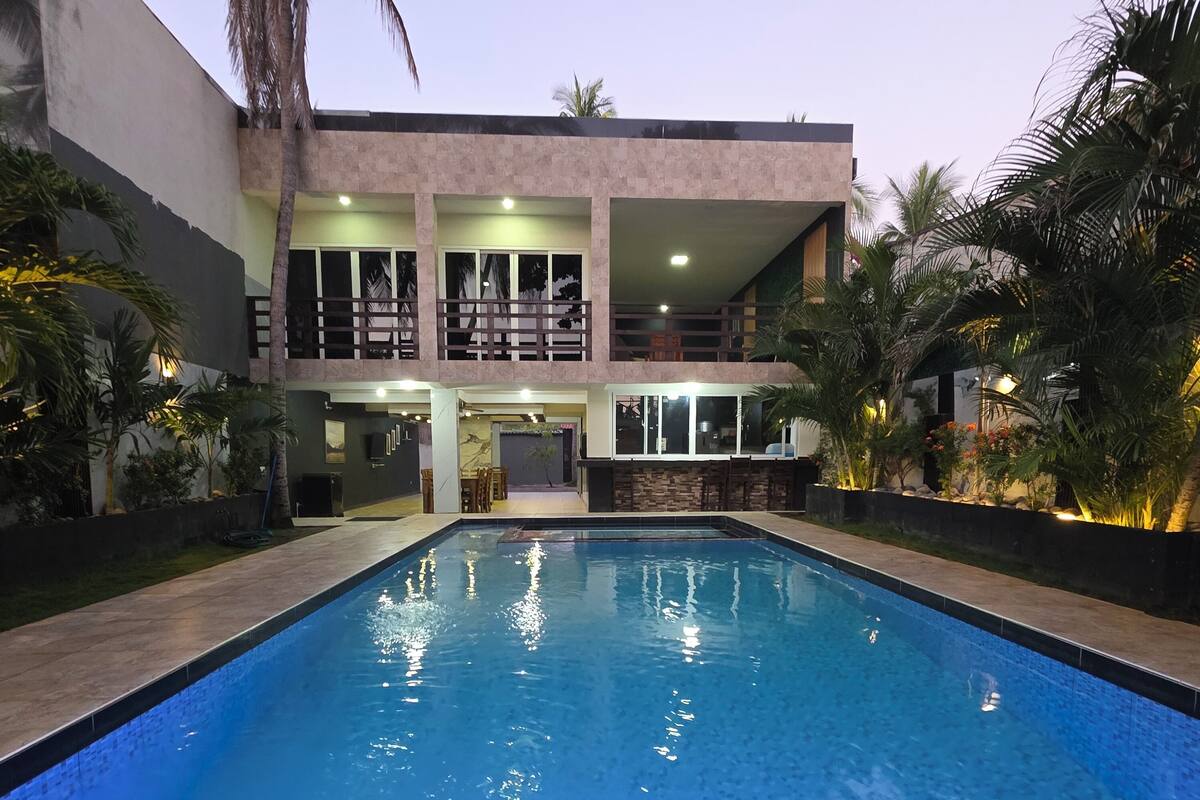 A two-story building with a swimming pool in front.