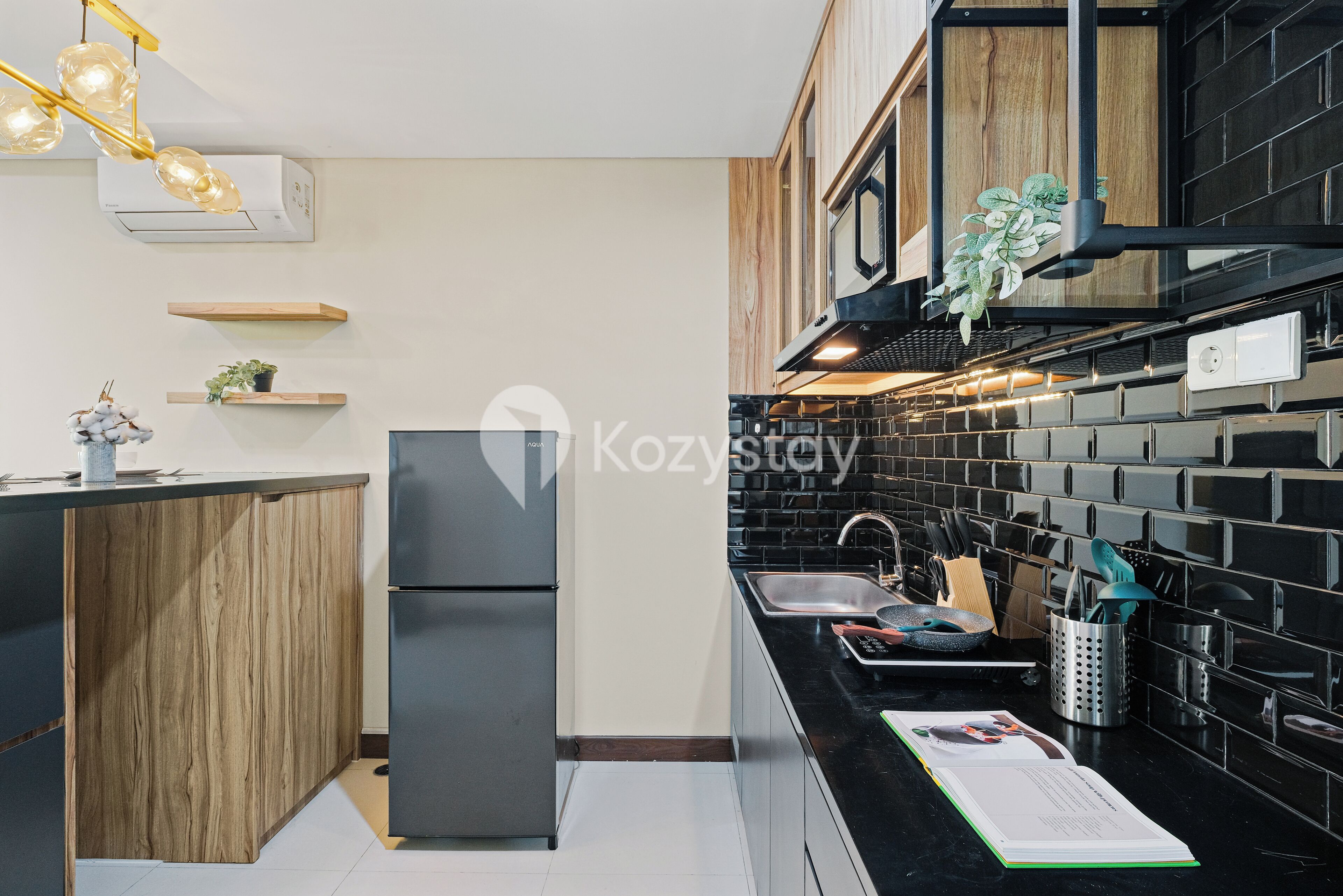 A modern kitchen with a black countertop, wooden cabinets, and a built-in oven.