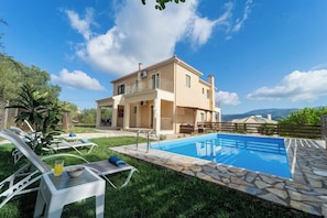 A two-story house with a swimming pool, a balcony, and a view of the mountains. - Belle Helen s Villa - 3 Bedrooms Billiard Pool (Kefalonia)