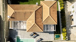 An aerial view of a property with a swimming pool, outdoor seating, and a tennis court. - Vasilopoulos Residences - Villa Kalliste (Kefalonia)