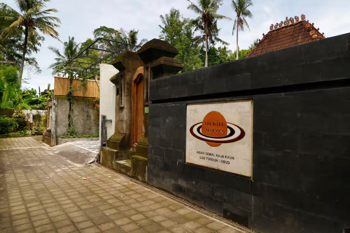 A gated entrance with a sign for Tri Datu Maison, indicating its location in Ubud, Bali.